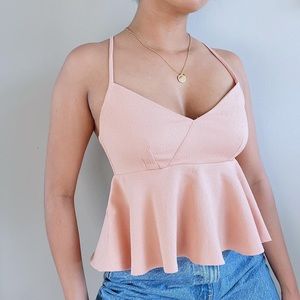 Gorgeous light peachy peplum top with adjustable straps and hooks at the back.